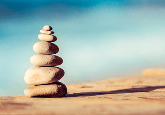 Pebbles stacked on top of each other on a beach